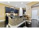 Bright kitchen with black cabinetry, tile backsplash, granite countertops, mosaic bar, and stainless appliances at 140 Sunstone Dr, Cary, NC 27519