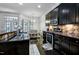 Kitchen with black countertops, stainless steel appliances, and a view of the dining area at 140 Sunstone Dr, Cary, NC 27519
