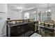 Kitchen island with a dark countertop overlooking the breakfast nook with large windows at 140 Sunstone Dr, Cary, NC 27519