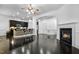 Living room with a bar top, stools, and fireplace that leads to the open kitchen area at 140 Sunstone Dr, Cary, NC 27519