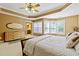 Carpeted main bedroom with ceiling fan, tray ceiling, bay window and dresser at 140 Sunstone Dr, Cary, NC 27519