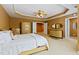 Main bedroom with neutral carpet, tray ceiling, with decoratively dressed bed and ensuite at 140 Sunstone Dr, Cary, NC 27519