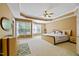 Bright and spacious main bedroom featuring a tray ceiling, sitting area, and an en-suite bathroom at 140 Sunstone Dr, Cary, NC 27519