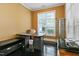Bright office space with dark granite desk, large window, and dark hardwood floors at 140 Sunstone Dr, Cary, NC 27519