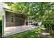 View of the screened-in porch with brick patio and green yard at 140 Sunstone Dr, Cary, NC 27519