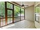 Screened porch features outdoor ceiling fan and view of backyard and trees at 140 Sunstone Dr, Cary, NC 27519