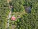 Aerial view of wooded property with house, garage, pool, and pond at 1656 Nc-42 Hwy, Moncure, NC 27559