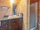 Cozy bathroom featuring wood paneled walls, a sink with vanity, and a glass-enclosed shower at 1656 Nc-42 Hwy, Moncure, NC 27559