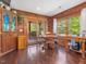 Cozy dining area featuring wooden table, chairs, wood walls, and a sliding glass door to the porch at 1656 Nc-42 Hwy, Moncure, NC 27559