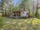 Exterior view of a cozy house with a covered porch, grill, and a well-maintained lawn at 1656 Nc-42 Hwy, Moncure, NC 27559