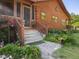 Charming home exterior with landscaped front yard, stone walkway, and inviting entrance with flowers at 1656 Nc-42 Hwy, Moncure, NC 27559