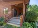 Charming front porch features natural wood finishes, greenery, and a ceiling fan at 1656 Nc-42 Hwy, Moncure, NC 27559
