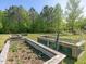 Outdoor living with raised garden beds for growing plants and vegetables in a natural setting at 1656 Nc-42 Hwy, Moncure, NC 27559