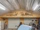 Spacious garage interior with overhead decorations, lights, and roll-up doors at 1656 Nc-42 Hwy, Moncure, NC 27559
