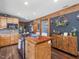 Charming kitchen features wooden cabinets, butcher block island, stainless steel appliances, and unique décor at 1656 Nc-42 Hwy, Moncure, NC 27559