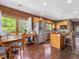Bright kitchen featuring wood cabinets, stainless steel appliances, butcher block island and dining area at 1656 Nc-42 Hwy, Moncure, NC 27559