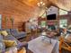 Inviting living room with wood walls, fireplace, and comfortable seating arrangement at 1656 Nc-42 Hwy, Moncure, NC 27559