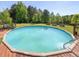 Enjoy this backyard pool with a spacious green lawn and surrounding trees, perfect for outdoor activities at 1656 Nc-42 Hwy, Moncure, NC 27559