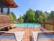 Backyard pool with wooden deck and lounge chairs, ideal for summer relaxation and outdoor entertainment at 1656 Nc-42 Hwy, Moncure, NC 27559