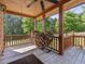 Outdoor porch area showcasing a wood flooring, railing, and wooden supports at 1656 Nc-42 Hwy, Moncure, NC 27559
