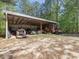 Open-sided shed used for storing tractors, lawn mowers and other machinery at 1656 Nc-42 Hwy, Moncure, NC 27559