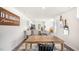 Open-concept dining area with wood table, black chairs, and a view into the kitchen at 168 Holmes Corner Dr, Smithfield, NC 27577