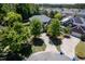 Aerial view of home featuring driveway, mature trees and landscaping at 1719 Willowcrest Rd, Durham, NC 27703
