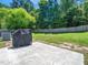 Large backyard with a covered grill and wooden fence at 1719 Willowcrest Rd, Durham, NC 27703