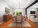 Elegant dining room with hardwood floors, a modern chandelier, and a bright view at 1719 Willowcrest Rd, Durham, NC 27703