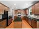 A beautifully appointed kitchen with an island, stainless steel appliances, and wood cabinets at 1719 Willowcrest Rd, Durham, NC 27703