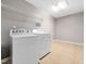 Functional laundry room featuring modern appliances, ample space, and tiled flooring at 1719 Willowcrest Rd, Durham, NC 27703