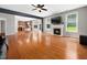 Open-concept living space featuring a fireplace, hardwood floors, and easy access to the kitchen at 1719 Willowcrest Rd, Durham, NC 27703