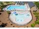 An aerial view of a splash pad and pool with tables and seating at 1719 Willowcrest Rd, Durham, NC 27703