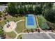 Aerial view of the tennis court and playground nestled among mature trees at 1719 Willowcrest Rd, Durham, NC 27703