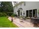 Inviting patio area with outdoor seating and a view of the well-manicured lawn and house exterior at 1904 Victoria Rd, Raleigh, NC 27608