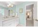 Bathroom with double sink, white cabinetry, and bright wall color at 1904 Victoria Rd, Raleigh, NC 27608