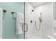 Shower with glass door and bronze fixtures in a modern bathroom at 1904 Victoria Rd, Raleigh, NC 27608