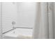 Shower and bathtub in updated bathroom with white subway tile at 1904 Victoria Rd, Raleigh, NC 27608