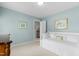 Bright bedroom with white daybed, light blue walls, and decorative artwork at 1904 Victoria Rd, Raleigh, NC 27608