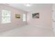 Inviting pink bedroom featuring two windows and neutral carpeting at 1904 Victoria Rd, Raleigh, NC 27608
