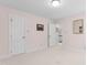 Bedroom with beige carpet, light pink walls, and two white doors at 1904 Victoria Rd, Raleigh, NC 27608