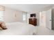 Bright bedroom shows a cherry wood dresser and connecting rooms at 1904 Victoria Rd, Raleigh, NC 27608