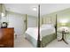 Bedroom with four poster bed, neutral carpet, and double closets at 1904 Victoria Rd, Raleigh, NC 27608