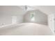 Spacious bonus room with vaulted ceiling, neutral paint, and natural light at 1904 Victoria Rd, Raleigh, NC 27608