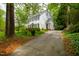 Charming white home with black shutters and a lush, green front yard at 1904 Victoria Rd, Raleigh, NC 27608