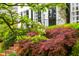 Charming home exterior, enhanced with lush greenery and vibrant flowers at 1904 Victoria Rd, Raleigh, NC 27608
