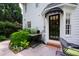 Charming home entrance with a black awning, black front door, and elegant decor at 1904 Victoria Rd, Raleigh, NC 27608