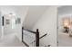 Bright hallway with white walls, carpet flooring, and staircase leading to the upper level at 1904 Victoria Rd, Raleigh, NC 27608