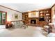 Spacious living room with a brick fireplace, built-in bookshelves, and neutral carpet at 1904 Victoria Rd, Raleigh, NC 27608