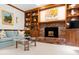 Comfortable living area with a brick fireplace, custom bookshelves, and cozy seating at 1904 Victoria Rd, Raleigh, NC 27608